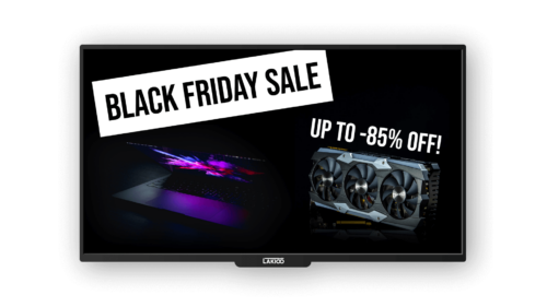 Digital display screen powered by LAKIOO software showing a Black Friday Sale advertisement, featuring a dramatic image of a gaming laptop and a high-performance graphics card with a bold claim of up to 85% off