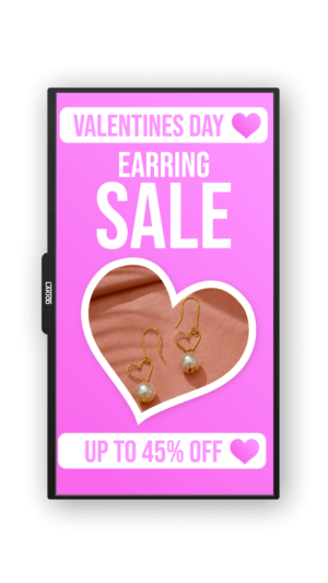 Vibrant pink advertisement for a Valentine's Day earring sale featuring a heart-shaped cutout with gold heart-shaped earrings with pearls, text announcing up to 45% off.